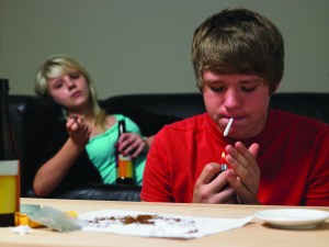 Teenage Couple Taking Drugs At Home