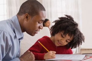 Father helping daughter with homework
