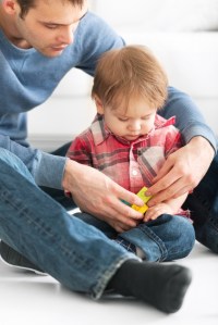 Father playing with infant son