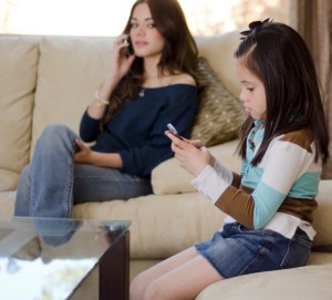 Mom and daughter on phones Small