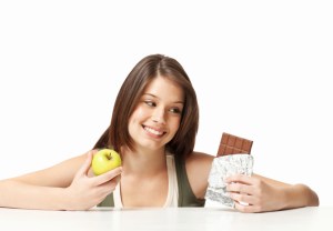 Teenage Girl Choosing Between Healthy and Unhealthy Eating