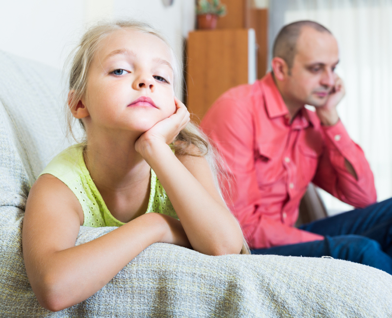 Unhappy small girl having conflict with father at home