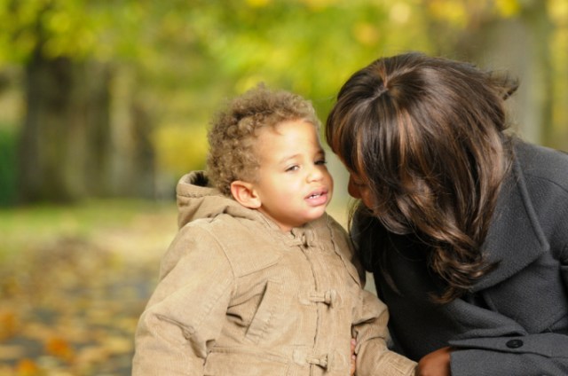 Baby/ Toddler Speaking To His Mother/ Carer In The Park