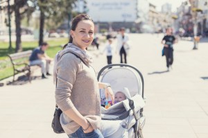 Mother walking in the city with a baby