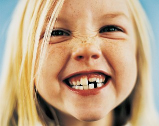 Portrait of a Young Girl With Gappy Teeth and Blond Hair