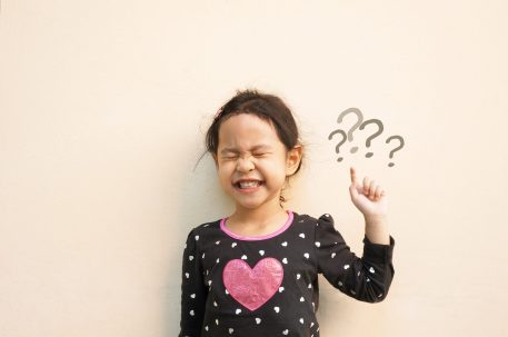 Little girl asking a question with her eyes closed