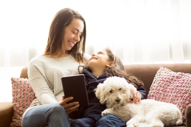 Mother, daughter and dog relaxed at home