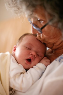 Grandma kissing baby