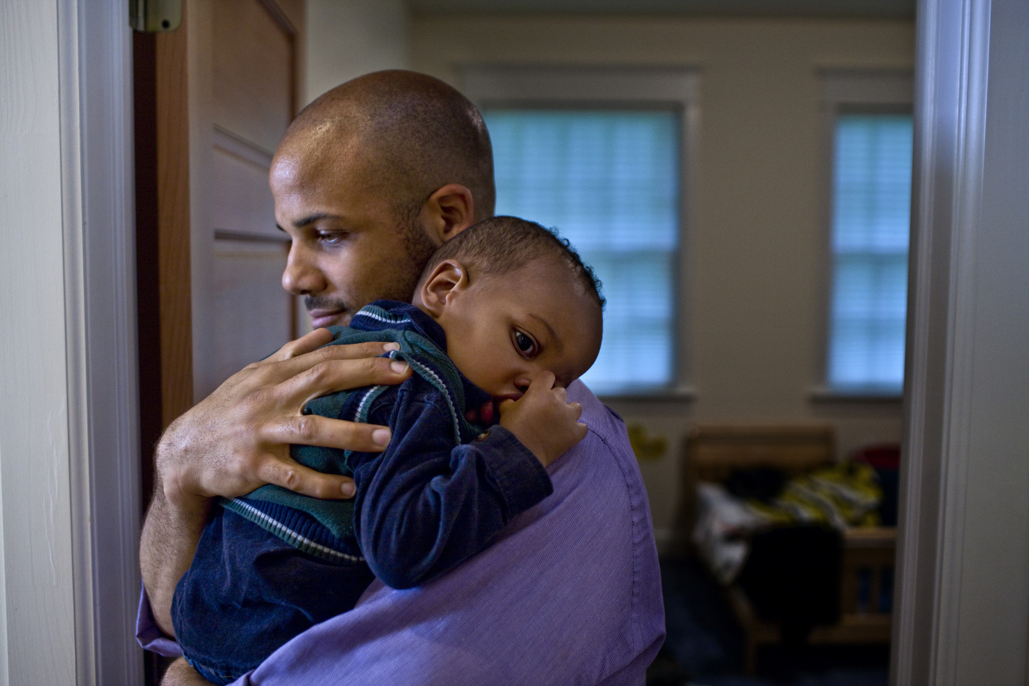 Father carrying sleeping son