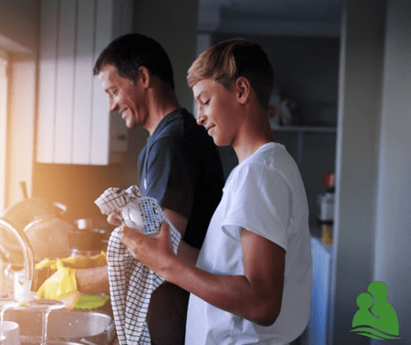 Dad and son washing dishes