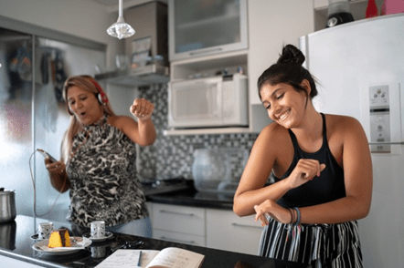Mom and daughter dancing in kitchen